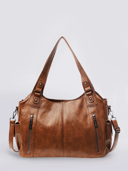 Braune Dakota Bag mit goldfarbenen Metallelementen